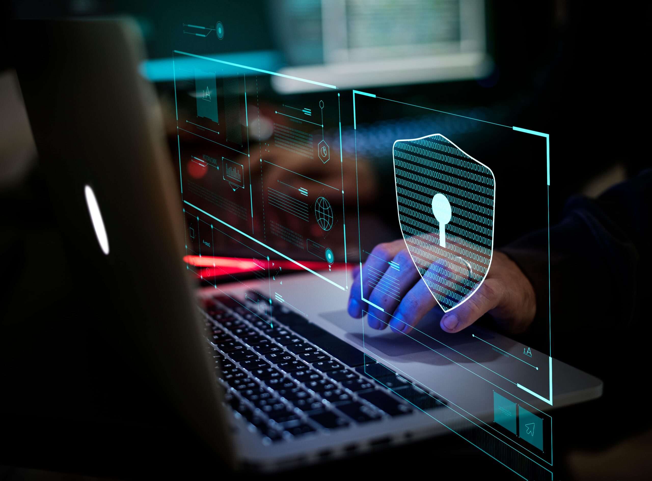 cybersecurity symbol and man's hand on laptop